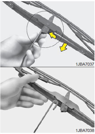 2. Compress the clip and slide the blade assembly downward.